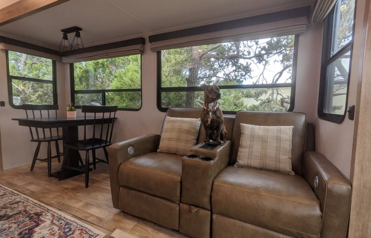 Theater seating and dining area with large windows for capturing great views