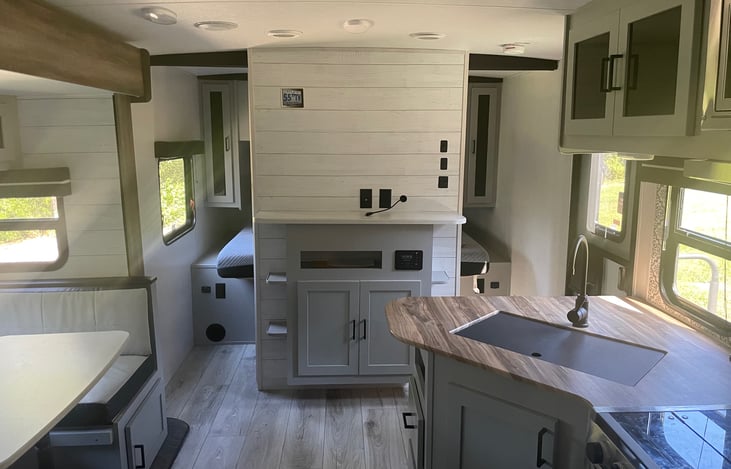View from the back of the camper facing the entertainment center and master bedroom.  The entrance door is to the right.