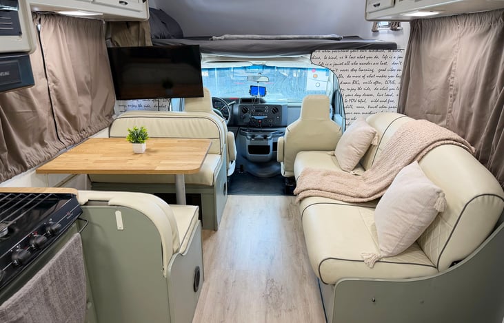Spacious RV interior with kitchen, seating & driver cabin – ready for your next Nevada road trip