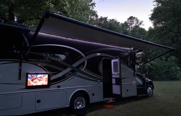 Outdoor Entertainment Area Features Lighted Awning and 40 inch Outdoor TV area