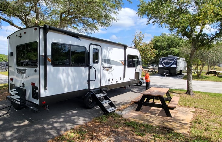 Very sturdy 3 steps with grab bar.  Large retractable awning that covers 3/4 of the side area.