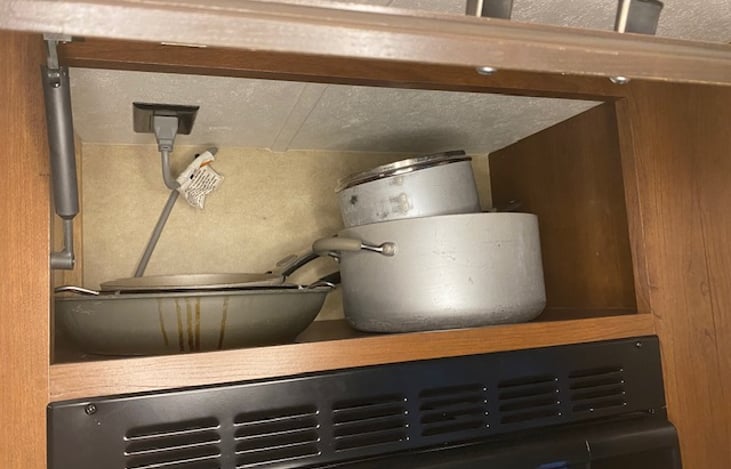 Above microwave storage, pots and pans.