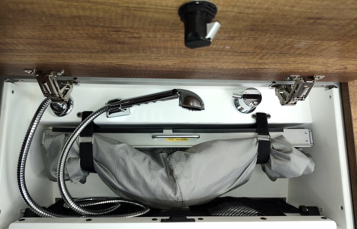 Halo Shower System in Upper Cabinet.  On slider rails that pulls out over the shower basin.