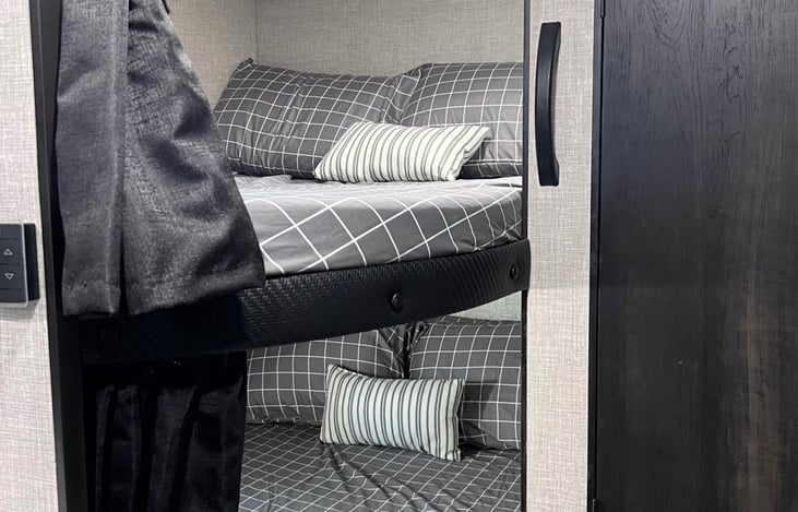 Double bunk w/ pillows and linens.