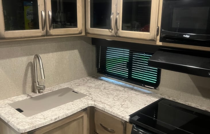 Kitchen with Cutting Board, Gas Cooktop and Oven, Microwave.