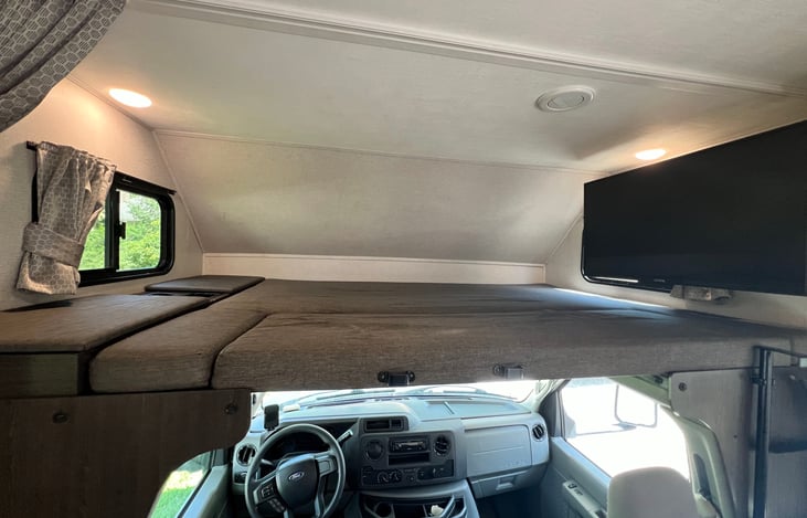 Over cab bunk. This is sized larger than a queen. Two adults can safely sleep up here.