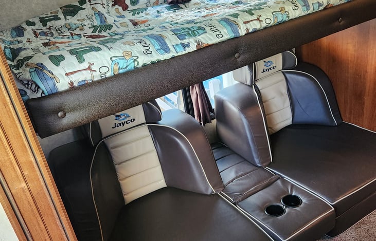 Bunk room with gamer chairs that fold into beds.
