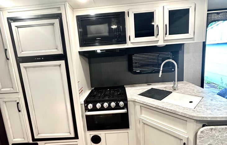 kitchen- oven, refrigerator, and sink.