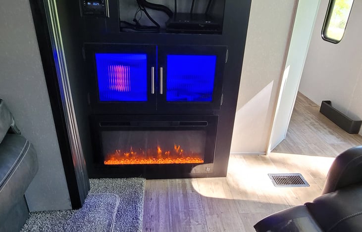 Electric "fireplace" has options for fan only or heat and 3 different colors of "flames."