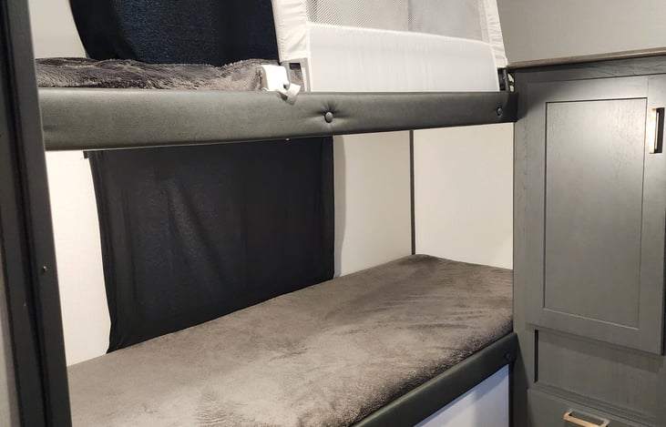 Second Bedroom bunk beds with closets, cabinets and a drawer for storage.