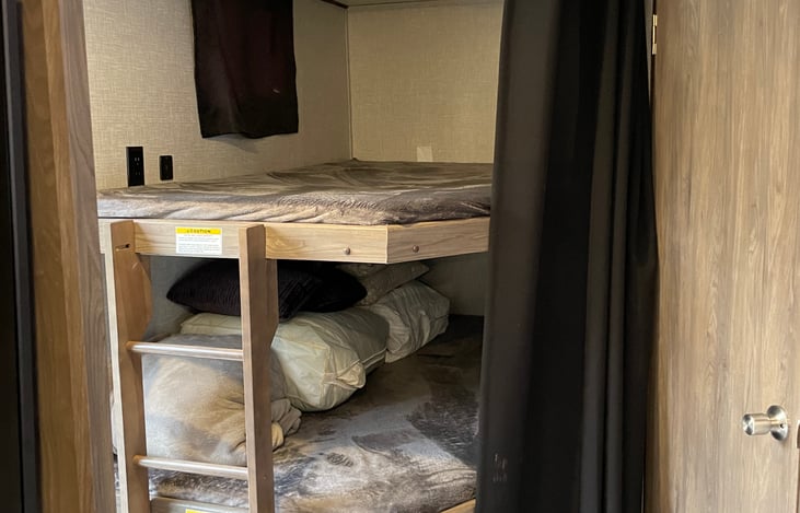 Bunk Beds with electric outlets, overhead lights and a window
