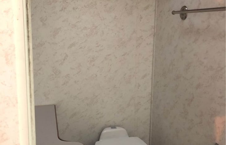 Cozy bathroom with storage, mirror and stocked with necessities.