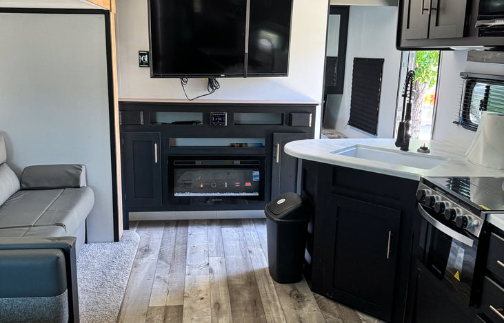 Looking at the RV from the Bunks. 

Electric fireplace and TV. Plus Bluetooth radio with speakers inside and outside.