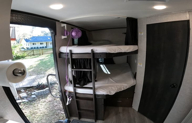 Bunk house with fans to circulate the air in them.