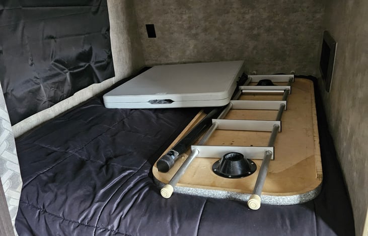 Full bed up front with the windows cover blacked out to stop the sun from waking you up.