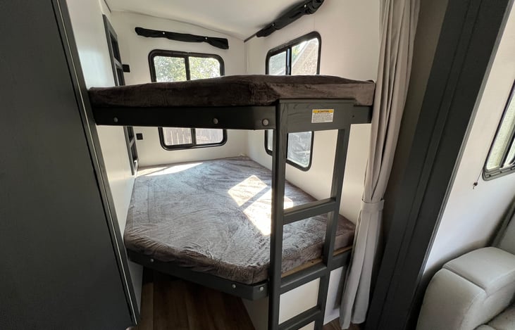 Full over full bunk located in the rear of the travel trailer. Top bunk has a 300lb MAX weight limit. Bunks comfortably sleep 1 adult or 2 children.
