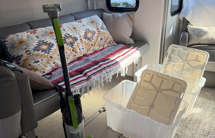 Vacuum cleaner and 2 storage bins under the versa lounge (couch)