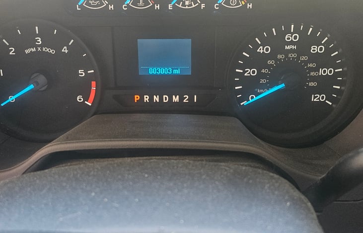 Dashboard, showing 3003 miles on the vehicle .