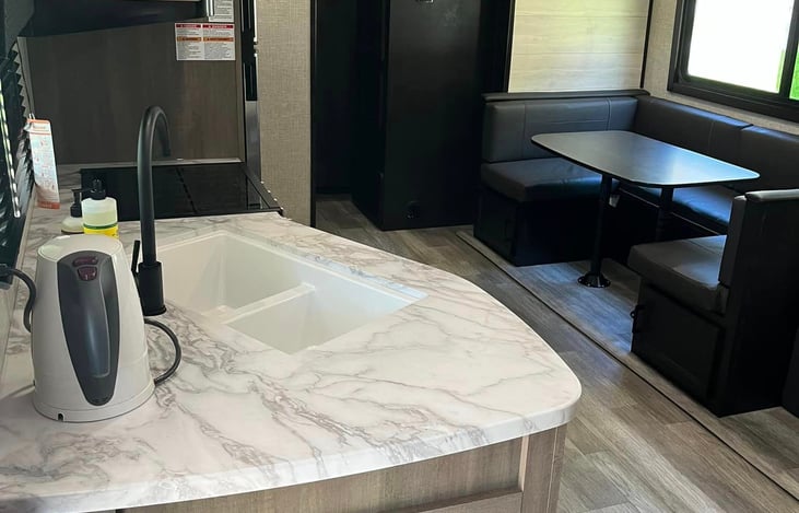 Entering at the door, you have the kitchen to the left & the main bedroom to the right.