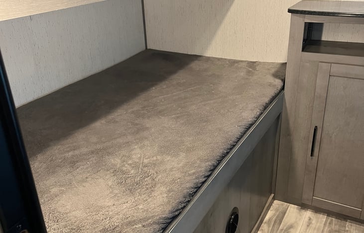 Bunk room, larger bed on bottom.