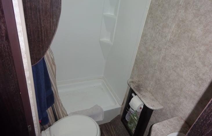 Shower, toliet, sink, two mirrored cabinets with storage.