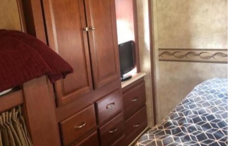 Another TV, Queen Bed and tons of storage.