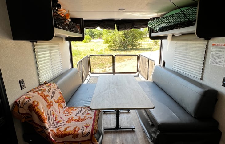 Back area setup for additional dining- The table can be moved & the benches double as two twin beds.