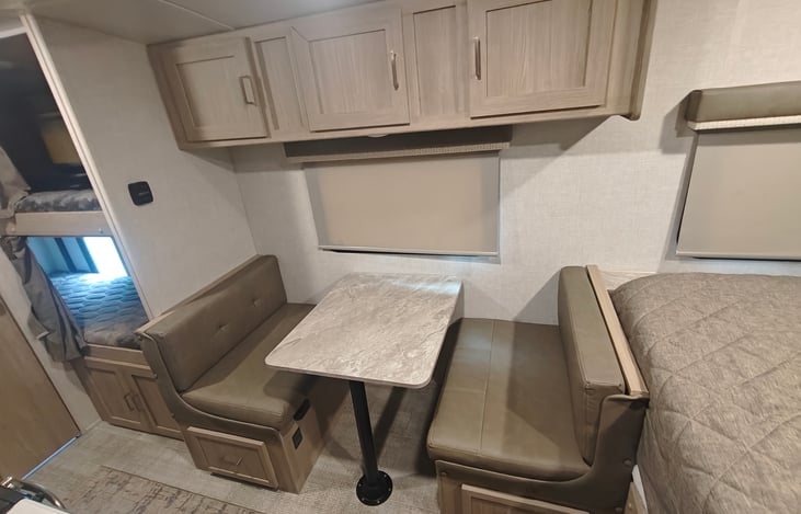 Dinette that fold into a bed. This area is also perfect for a pack n play