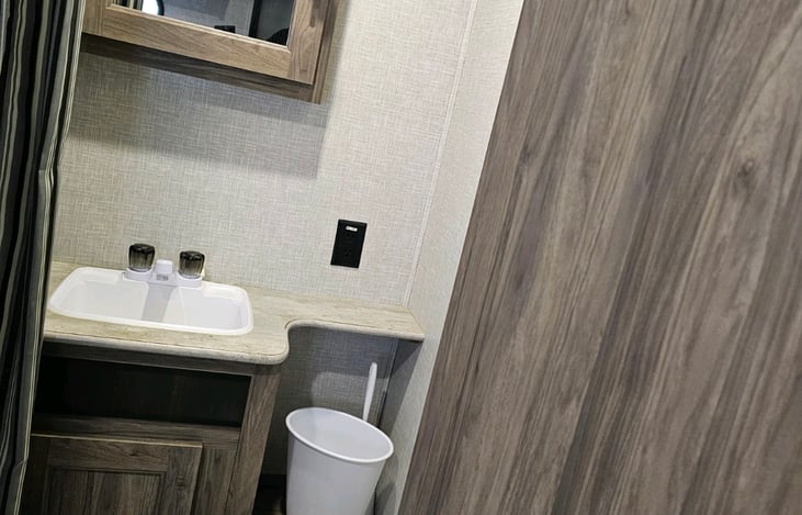 Full bathroom equipped with sink, medicine cabinet and undercounter storage.