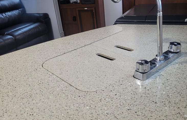 upgraded kitchen faucet over double sink with granite counter