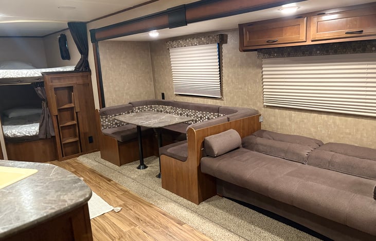 Sofa bed and dinette convert into sleeping areas.