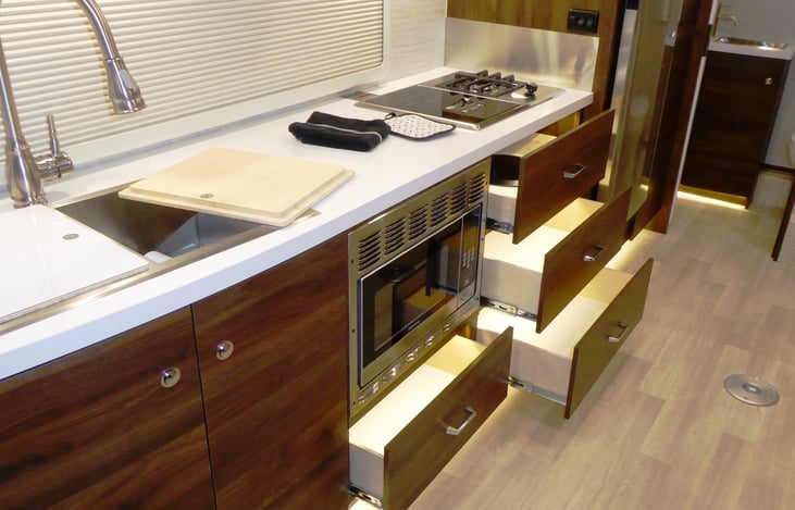 Soft close lighted storage, Large double  sink, gas and induction stove top, full size refrigerator & freezer, Under sink storage & water filter, Spray  nozzle