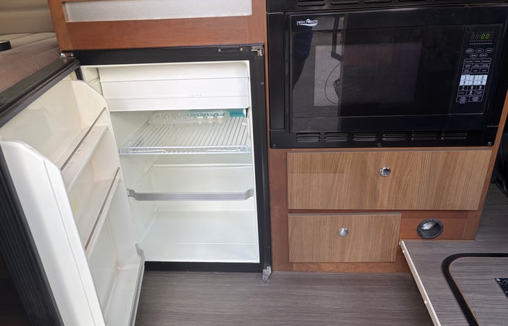 Fridge with small freezer in it, microwave/convection oven.