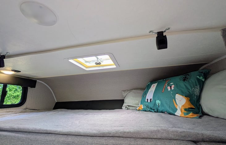 Bed above the cab. 87" x 48 " The bunk over the cab is roomy. Window, Vent and light.