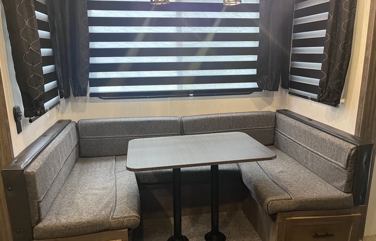 This dinette folds down for a double sleeper. It also gives space for meals. We typically add a blanket under the seats to cozy up on those fall/winter nights!