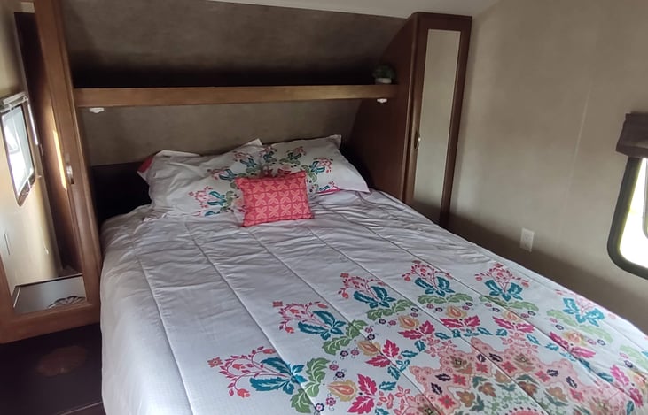 Queen bed in the front bedroom with side wardrobes