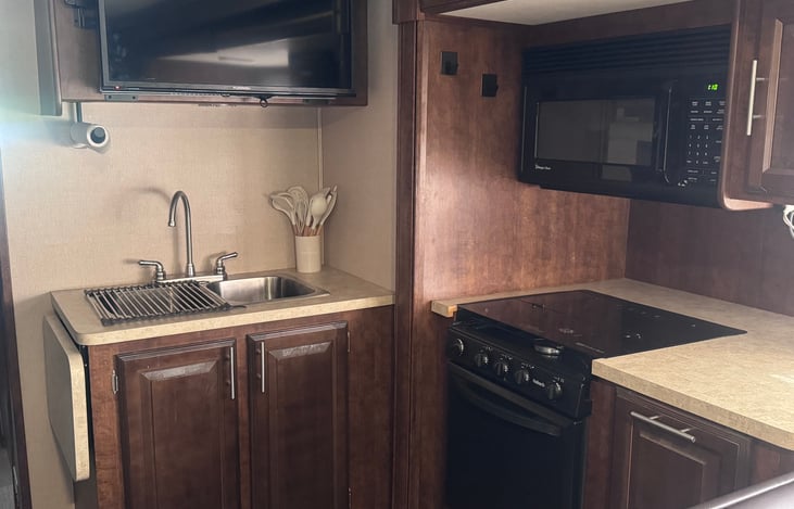 Kitchen with all the appliances and TV