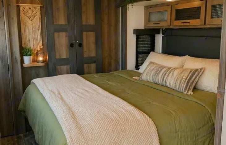 A private sanctuary featuring a 70" x 80" king-sized bed on a slide-out. It has its own dedicated exterior entry door, and a floor-to-ceiling closet.