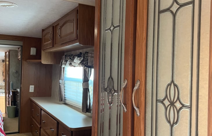 Linen closet across from main bath and leading into master bedroom. Sink beside the closet.