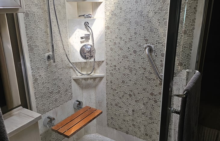 Largest shower we could find in an RV!  Rain shower head and separate handheld shower wand plus bench seating in the shower