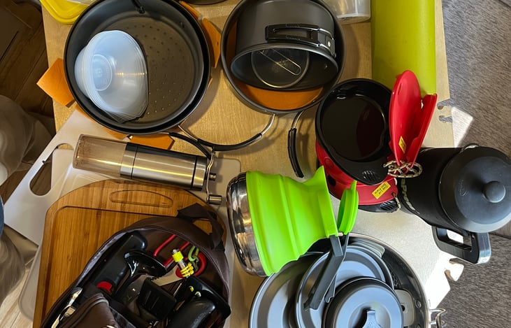 3 pots, 2 pans, coffee/ tea press, tea kettle, bowls, cups, coffee grinder,  cutting boards and serving board, hand shaker bottle, kitchen tools and more (even got salt and pepper shakers)