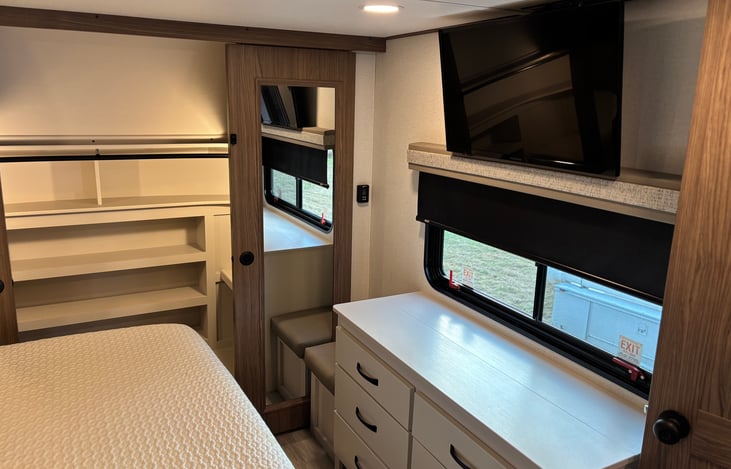 Dresser and closet space in primary bedroom, along with a Fire TV