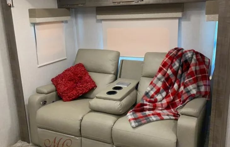 "Micro Easy" has a 67" reclining theater seating assembly nestled into the slide-out, featuring wireless device charging, lumbar positioning, and full reclining for relaxation and even sleeping.