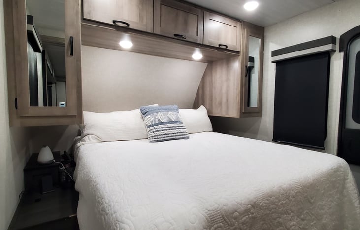 Queen sized bed with a dedicated ac unit.