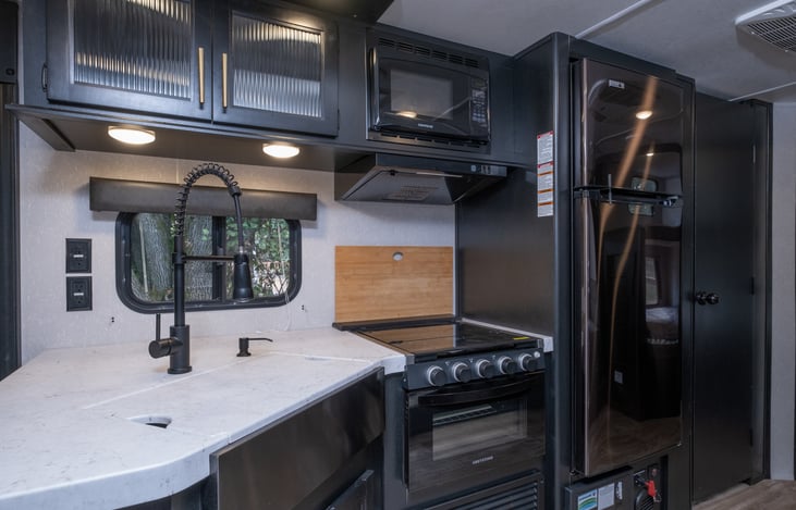 Cousin Kyle has a spacious kitchen with a sink and oven covers to add more space.