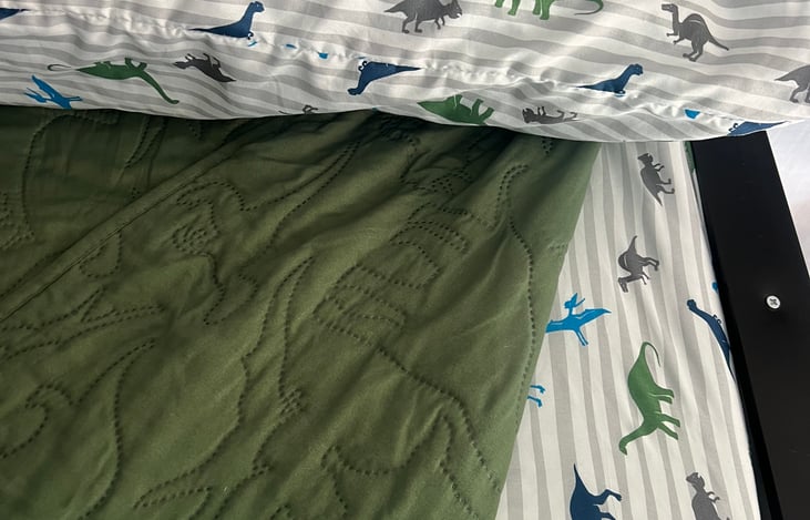 Top bunk includes pillow, sheet and quilt