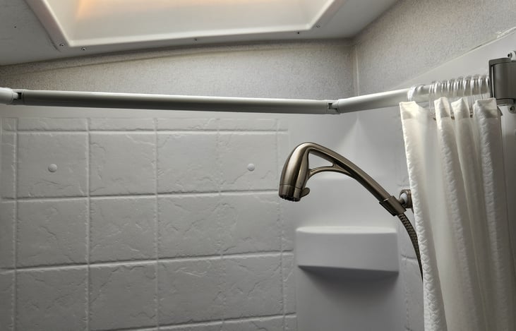 Notice the shower rod. It expands the curtain to give more space in the shower