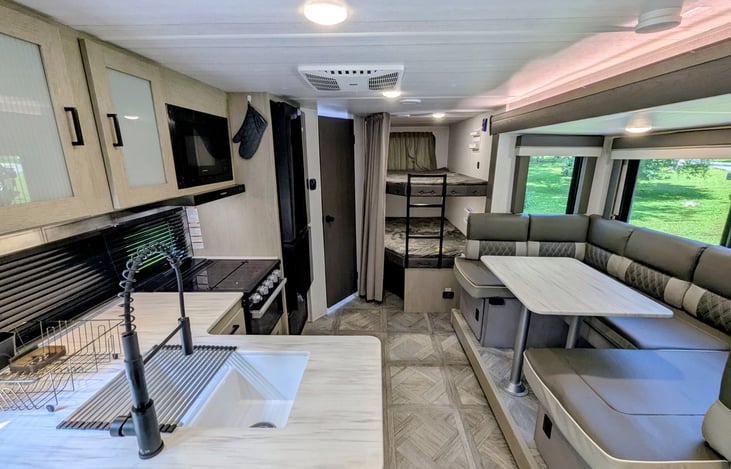 Bright and modern interior with spacious dinette with large windows. Large kitchen with plenty of counter space. Large bunks. TV with fireplace.