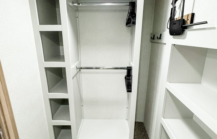 Large walk in closet with shoe rack.