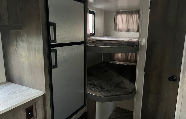 Extra large bunk beds with plush padding. Upper bunk has 300 lbs. weight limit capacity and USB charging ports. Each bunk has its own window and ceiling light fixture.